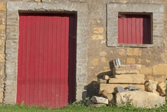 Red door and windows, historic house façade, yellow sandstone, Marville, Renaissance village,