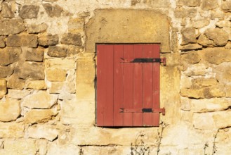 Red wooden window, historic house façade, yellow sandstone, Marville, Renaissance village,