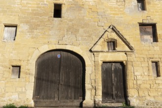Wooden door, window, historic house facade, yellow sandstone, Marville, Renaissance village,