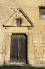Wooden door, historic house façade, yellow sandstone, Marville, Renaissance village, Département