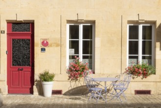 Entrance decorated with flowers, table and chairs, Marville, Renaissance village, Département