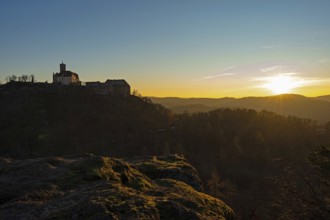 View of Wartburg Castle with the setting sun and the Thuringian Forest, Eisenach, Thuringia,
