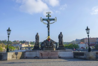 Statuary of the Holy Crucifix and Calvary on Charles Bridge, in Prague, Czech Republic, in sunny