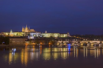 Vltava river with famous Hradcany castle and St. Vitus Cathedral in Prague, Czech Republic, by