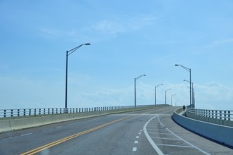 An empty bridge under a clear blue sky conveys a calm and lonely atmosphere, A. Max Brewer Bridge,