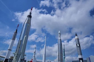 Various rockets rising into the blue sky, surrounded by clouds, Kennedy Space Centre Visitor