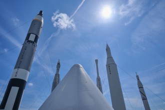 Rockets under bright sunshine, with a cloud in the blue sky, Kennedy Space Centre Visitor Complex,