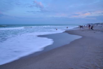 Wave scene on the beach in the evening with people in the background, Cocoa Beach, Port Canaveral,