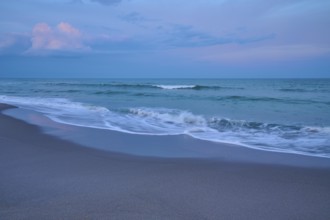 Beach scene with calming waves and blue evening sky, Cocoa Beach, Port Canaveral, Florida, USA