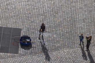 View from the lantern of the Church of Our Lady to the Neumarkt with street artist who delights