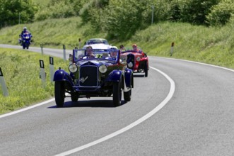 A blue and a red classic car driving one behind the other on a road, classic car, car race, Mille