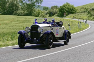 A white and blue classic car with driver on a sunny country road, classic car, car race, Mille