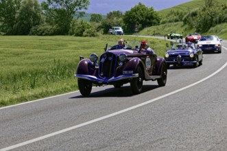 A red classic car leads a group of classic cars on a country road, classic car, car race, Mille