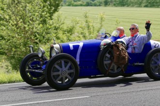 Blue classic car with two men on a country road under a sunny sky, classic car, car race, Mille