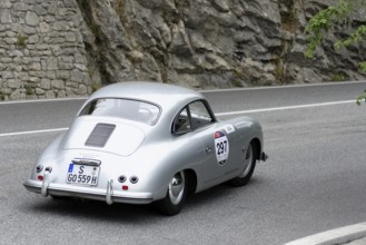 No. 297 Porsche 356 1500 Speedster, model year 1954, Silver vintage car driving on a road along a