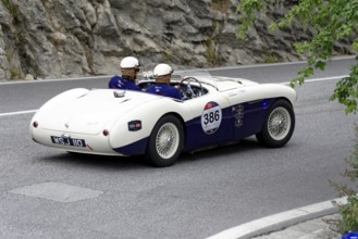 No. 386, Austin Healey 100 S, built in 1955, white classic car convertible travelling on a winding