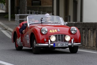 No.424, Triumph TR 3 Sports, built in 1956, A red vintage convertible with two people and round