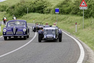 Purple vintage car and black car driving side by side on country road, vintage car, car race, Mille