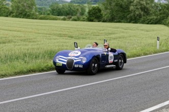 Blue vintage car on country road with green fields and trees in the background, vintage car, car