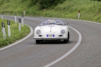 White Porsche vintage convertible on a winding country road, classic car, car racing, Mille Miglia,