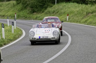 Open-top classic car followed by another car on a country road, classic car, car race, Mille