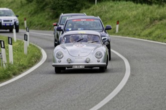 Silver classic car leads a group of cars on the road, classic car, car race, Mille Miglia, 1000