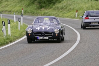 Black Mercedes classic car on a winding country road during a race, classic car, car race, Mille