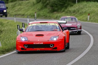 A red Ferrari racing car drives dynamically in front of a classic car, classic car, car race, Mille