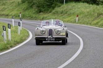 Classic vintage car with two occupants on a country road, vintage car, car race, Mille Miglia, 1000