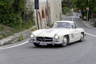 No.390, Mercedes-Benz 300SL W 198, model year 1955, White Mercedes vintage car driving on a winding