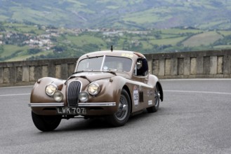 No. 236, Jaguar XK 120 Coupé, built in 1952, Brown vintage car on winding road with picturesque