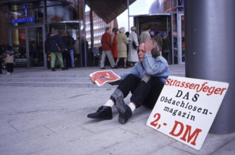 Berlin, DEU, 18.10.1998 -- Chris, seller of a homeless magazine Straßenfeger, sits in front of the
