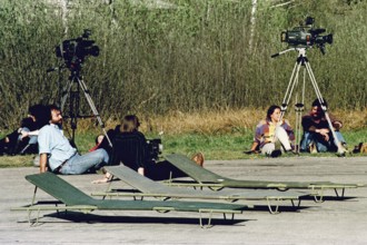 BIH, Bosnia, Tuzla, 01.05.1993 Cameramen wait their assistants together for the arrival of refugees