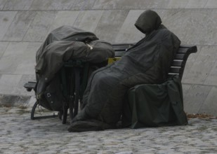 DEU Germany Germany Berlin A homeless person sits on the banks of the Spree opposite the Federal