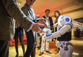 ITA Italy Castelfalfi participants greet a robot during a conference for tourism managers
