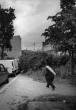 DEU, Germany, Berlin, 12.03.2006, A man wearing a Berlin bear costume heads towards