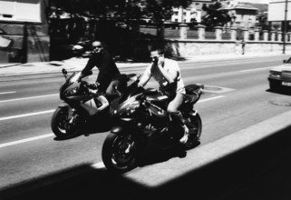 BIH, Bosnia, Sarajevo, 22.07.2005, motorcyclist without helmet with cellphone and sunglasses