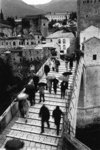 BIH, Bosnia, Mostar, 07.10.2005, People walk across the old bridge