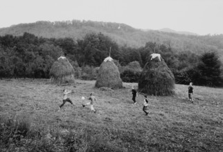 BIH, Bosnia, Tuzla, 05.10.2005, children playing soccer next to haystacks