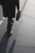 Man with briefcase crosses pedestrian traffic light in Friedrichsstraße