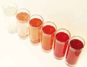 Five glasses of red liquid on white background, São Paulo, Brazil