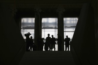 Media representatives wait at the end of the entrance steps at the start of the press tour in front