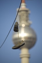 GERMANY Berlin shoes on a power line with a view of Alex. Germany Berlin Shoes are hanging over an