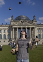 GERMANY Berlin Juggler on the meadow in front of the Reichstag in Berlin. Germany Berlin A juggler