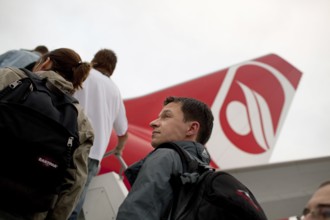 DEU Germany Berlin Passengers board an Air Berlin aircraft on the runway at Berlin-Tegel Airport.