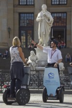 GERMANY Berlin Segway drivers during a guided city tour in front of the Schiller Monument on the