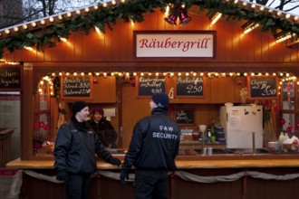 Berlin 2010-11-24 Security guards in front of the snack bar at a Christmas market. DEU Berlin