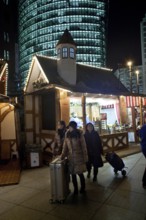 Berlin 2010-11-24 tourists with suitcases at the Christmas market at Potsdamer Platz DEU Berlin