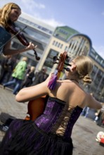 GERMANY Berlin Street musicians in corsets play violin and cello at Hackescher Markt. Germany