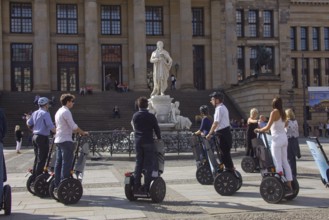 GERMANY Berlin Segway drivers during a guided city tour in front of the Schiller Monument on the